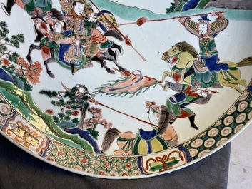 A Chinese famille verte dish with warriors on horseback, Kangxi